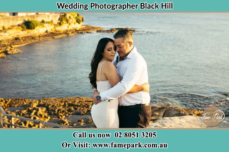 Photo of the Bride and Groom hugging Black Hill