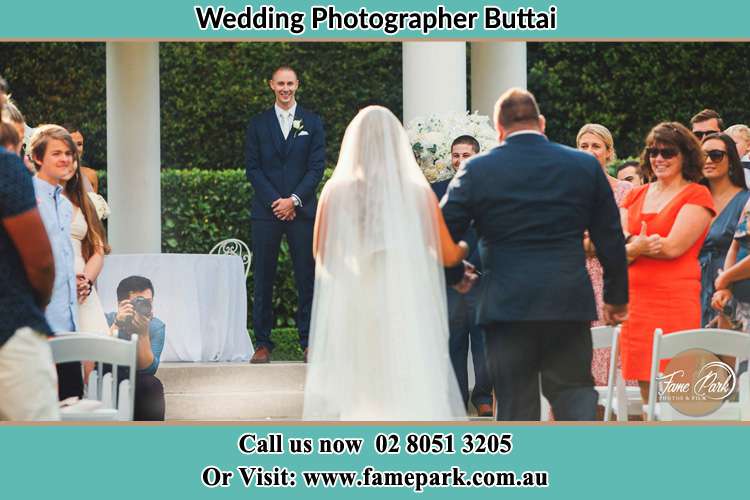 Photo of the Bride and Groom walking to Altar Buttai