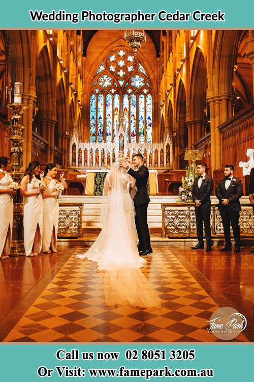 Photo of bride and groom at Church altar Cedar Creek