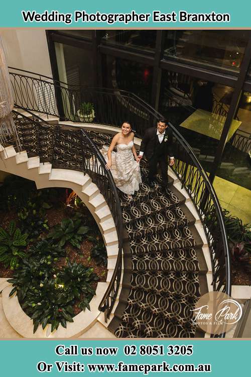 Photo of the Bride and Groom going down the stairs East Branxton