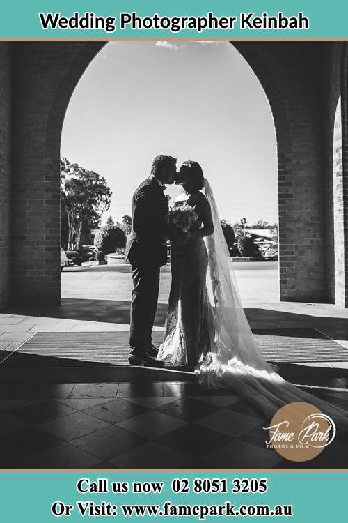 Bride and Groom kiss in front of the church Keinbah