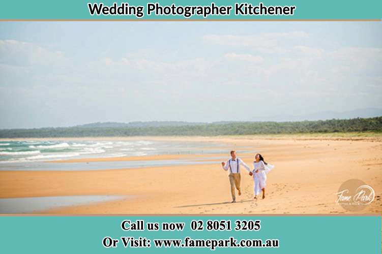 Photo of the Groom and the Bride walking at the sea shore Kitchener NSW 2325