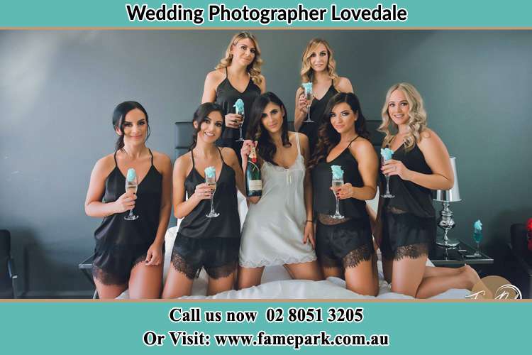 Photo of the Bride with her bridesmaids on the bed Lovedale NSW 2325