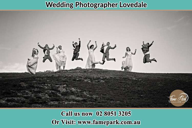 Bride and Groom Jump up the hill with the secondary sponsors Lovedale