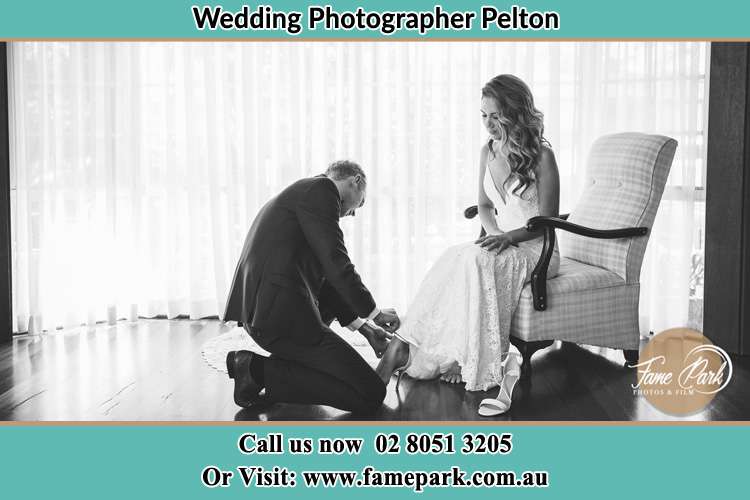 Groom removing the Bride's Shoes Pelton