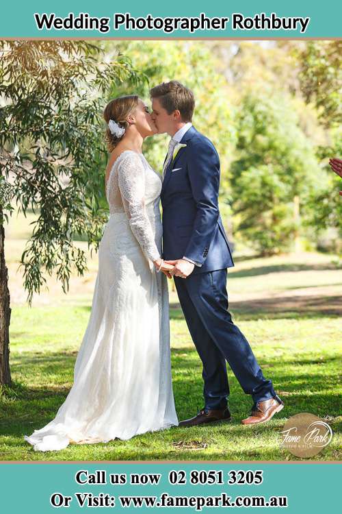 Bride and Groom Kiss in the Bush